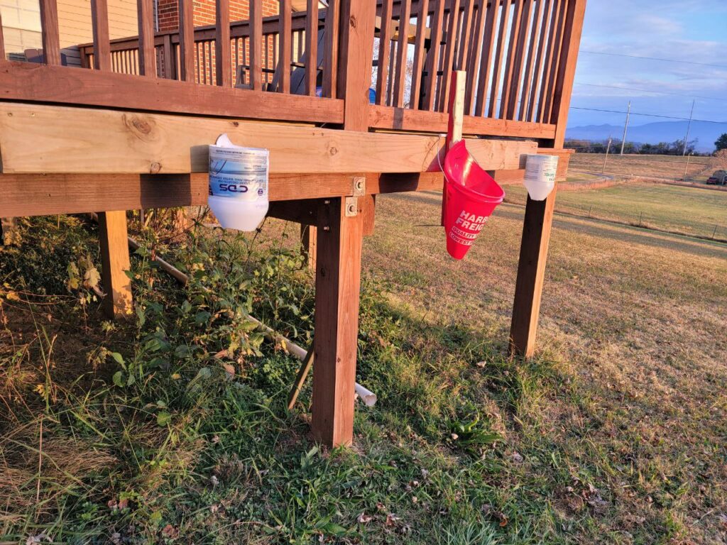 Image of our cone station attached to our deck. We used a bucket cone for inverting the chickens and attached it to our deck